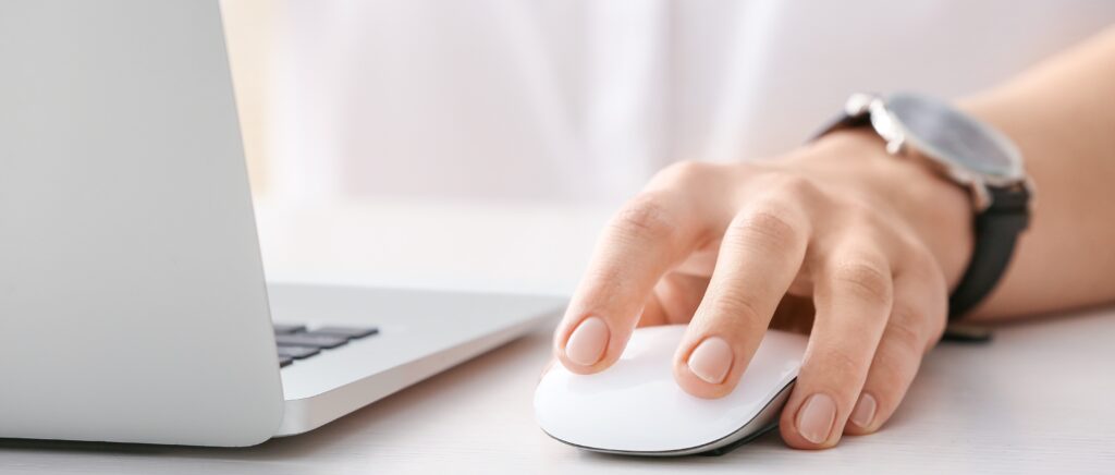 Woman working on a computer using a mouse