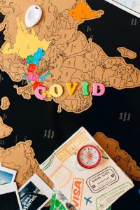 A world map with the word covid in block letters