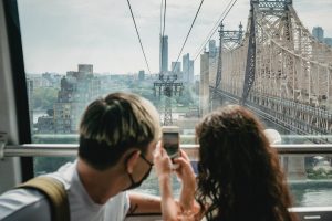 A couple taking a photo on a bridge tram