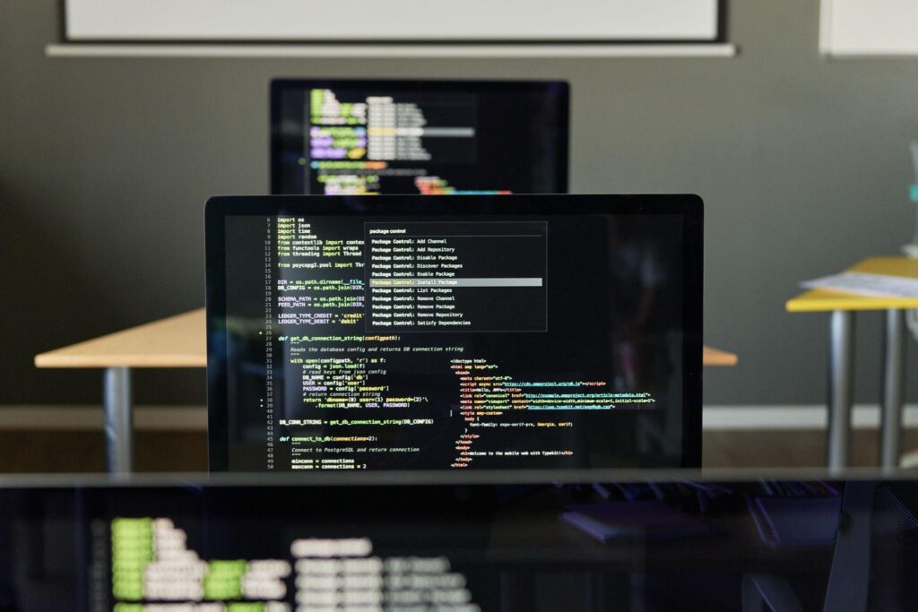 computer screens lined up with coding on them.