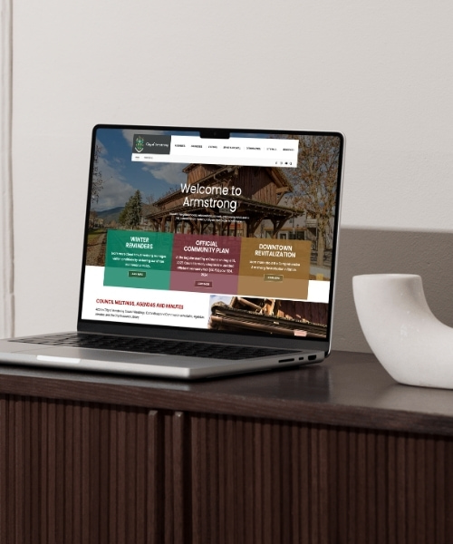 City of Armstrong website homepage on a laptop on a wood side bar.