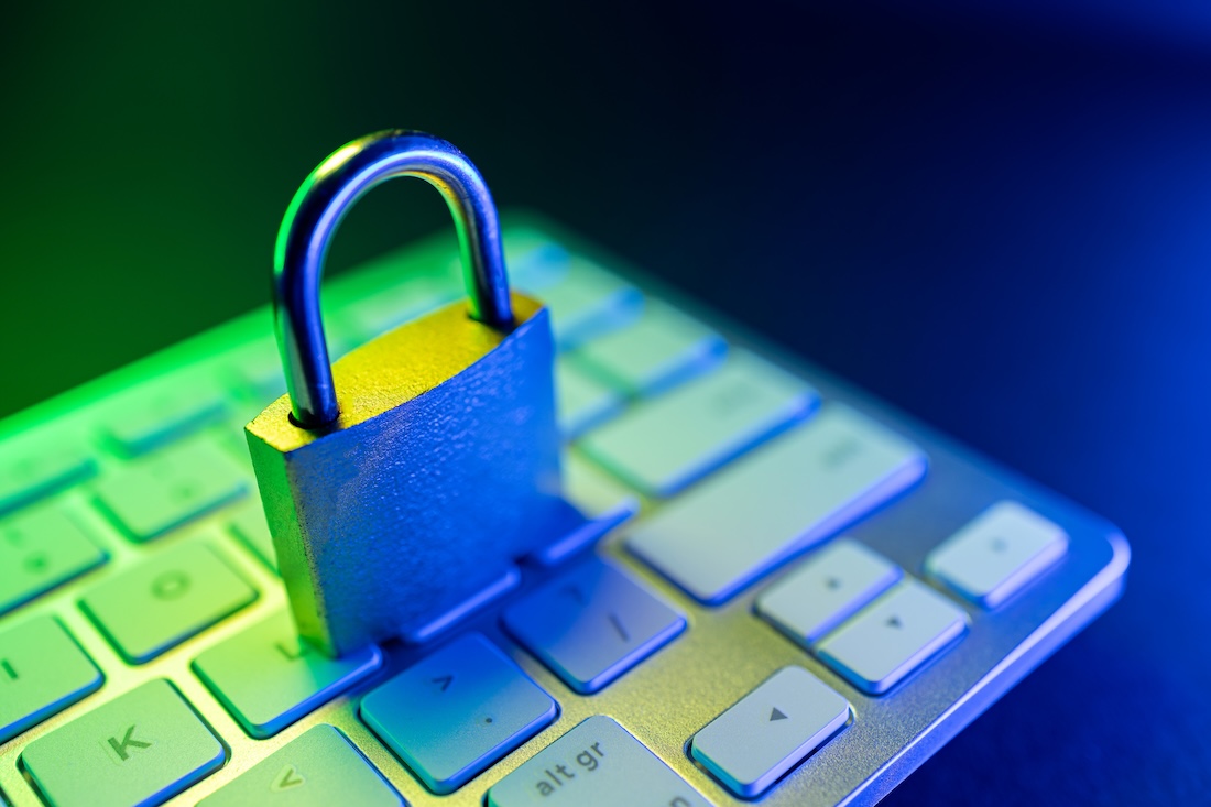 A metal padlock rests on a computer keyboard, symbolizing digital security.